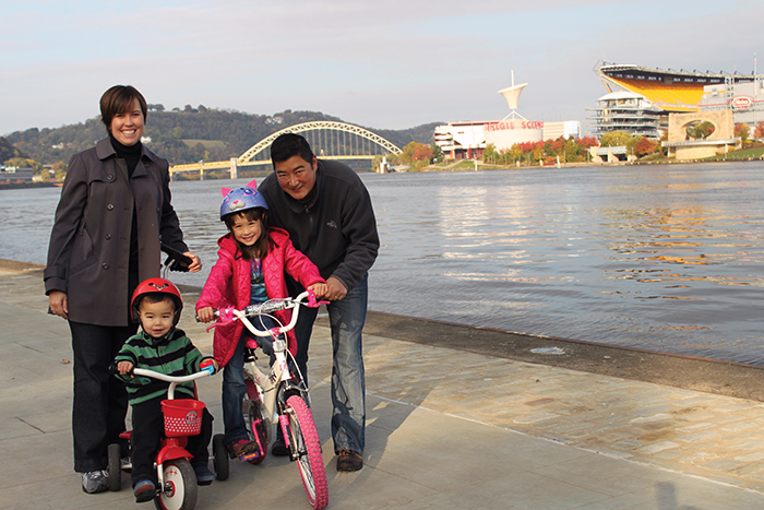 Family on Point State Park promenade with kids on bikes - photo by Alan Whittington